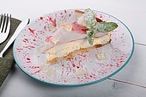 Cheesecake slice served wiuth mint