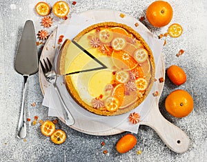 Cheesecake with slices of orange and kumquat. Top view