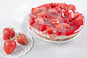 Cheesecake with strawberry and fresh berries on gray table