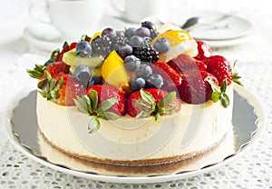 Cheesecake topped with berries and fruits photo