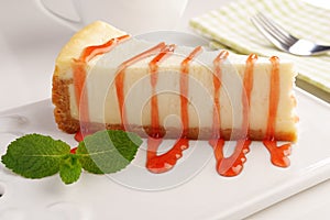 Cheesecake under strawberry sauce