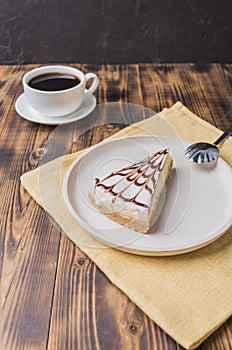 Cheesecake on a white plate with a coffee