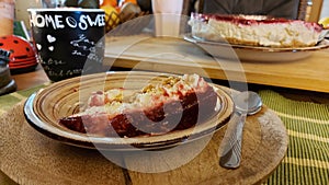 Cheesecake on the wooden table. Fruit cake with cheese filling. Coffee cup with text.