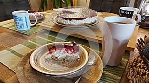 Cheesecake on the wooden table. Fruit cake is sliced and served.