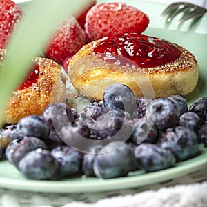 Cheesecakes with raspberry jam, berries, served with a cup of tea, cheesecakes