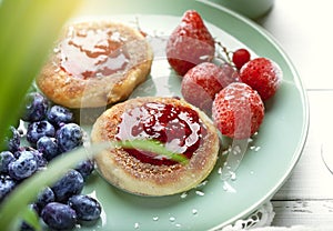 Cheesecakes with raspberry jam, berries, served with a cup of tea, cheesecakes