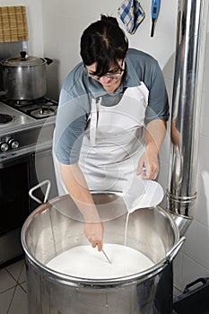 Cheesemaker pours rennet