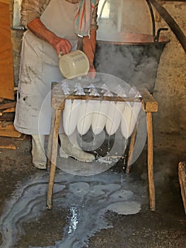 Cheesemaker during the production of cheese in a mountain hut