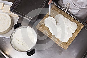Cheesemaker puts fresh cheese on the rush for a typical process