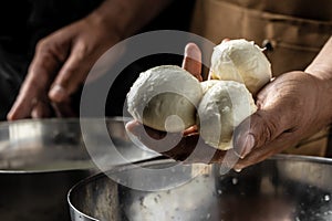 Cheesemaker, showing freshly made mozzarella. The homemade cheese maker produces caciocavallo. Pasta filata, Traditional Italian