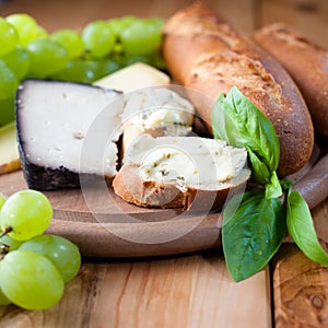 Cheeses with baguette,grapes and herbs