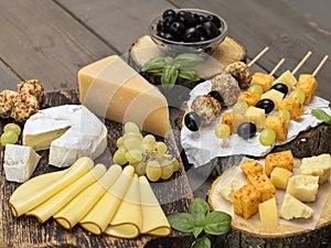 Cheeses of different varieties on a wooden background. photo
