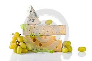 Cheeses and grapes with salad isolated on a white background