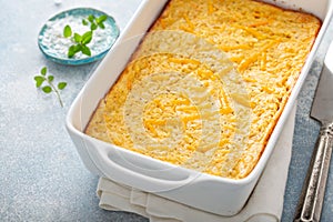 Cheesy cornbread freshly baked in a pan