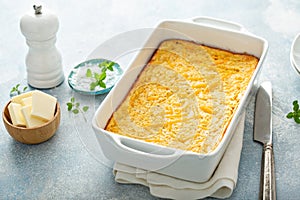 Cheesy cornbread freshly baked in a pan