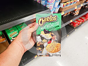 Cheetos Mac `N Cheese at store, hand