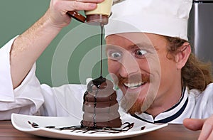 Chef added chocolate sauce at piece of cake photo