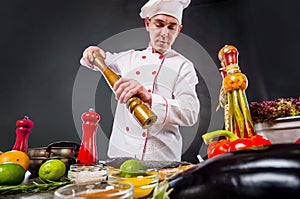 Chef adding peppers mix to fish using big pepper mill