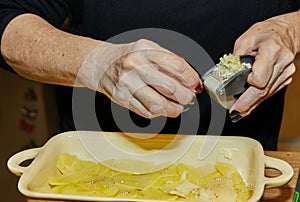 Chef adds garlic to Potato Gratin and Sweet Potato with Provencal Herbs