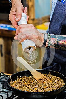 Chef adds ingredients to meals