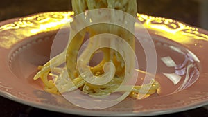 Chef Adds Spaghetti from Frying Pan to Plate