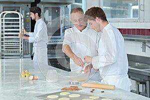 Chef assistant learning to make dough photo