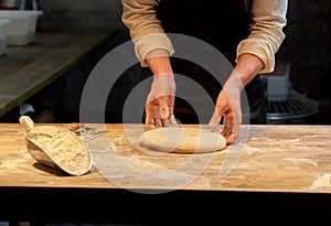 Chef or baker cooking dough at bakery