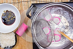 Chef boiling kamaboko fish cake in pot