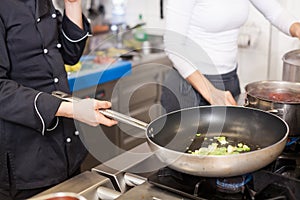 Chef or braising meat in a frying pan