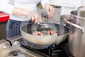 Chef or braising meat in a frying pan photo