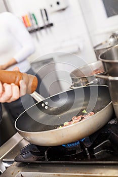 Chef or braising meat in a frying pan photo