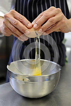 Chef breaking an egg