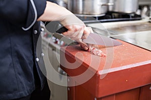 Chef or butcher dicing meat