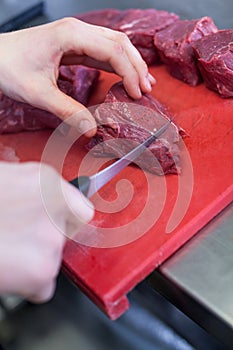 Chef or butcher dicing meat
