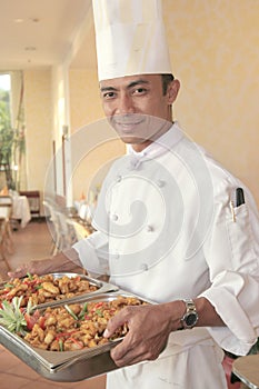 Chef carrying food for buffet