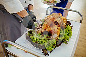 A Chef Carving Roast Turkey In A Live Display In Restaurant