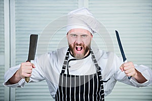 Chef choose professional tools. Chef hold cleaver knife tool ready to chop ingredients. Man wear apron cooking in