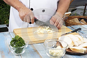 Chef chopping garlic for cooked Garlic bread