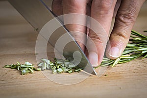 Chef chopping a rosemary branch