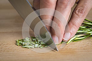 Chef chopping a rosemary branch