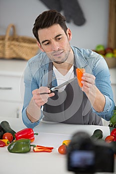 chef chopping yellow chili peppers