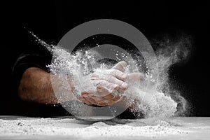 Chef clap white flour dust man hand on black background