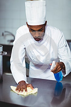 Chef cleaning kitchen counter