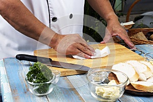Chef cleaning wooden broad with tissue paper