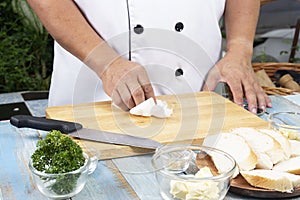 Chef cleaning wooden broad with tissue paper