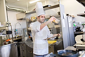 Chef with clipboard doing inventory at kitchen