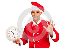 Chef with clock gesticulate five minutes