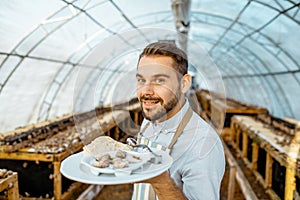 Chef cook with cooked snails on a farm