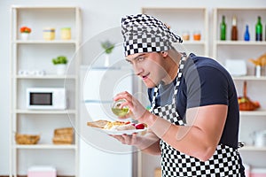 The chef cook cooking a meal breakfast dinner in the kitchen