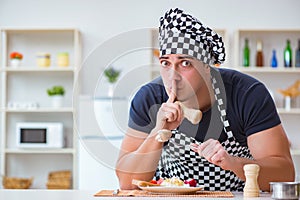 The chef cook cooking a meal breakfast dinner in the kitchen